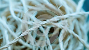 Closeup of a tangled ball of string with knots and loops intertwined representing the confusing and overwhelming