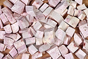 closeup of taro root vegetable, eddo malanga, green background