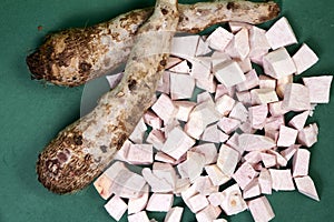 closeup of taro root vegetable, eddo malanga, green background
