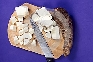 closeup of taro root vegetable, eddo malanga, purple background