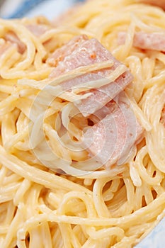 Closeup of tasteless spaghetti carbonara with ham
