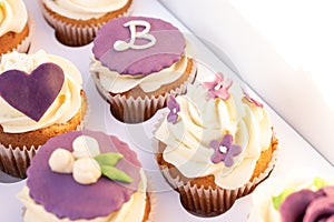 Closeup of tasty homemade cupcakes with sugar icing in paper box