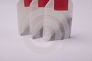 Closeup of tea bags with red label  on white background