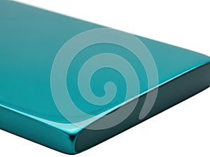 Closeup of a tealcolored object corner with a smooth edge isolated on white background