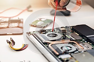 closeup of technician blow out dust from computer fan