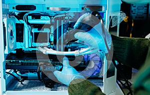 Closeup of technician repairing PC hardware using soldering tool in high-tech lab, representing technology maintenance, innovation