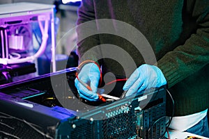Closeup of technician testing computer motherboard with multimeter in modern lab, representing precision, innovation, and