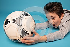 Closeup of a teenage boy, goalkeeper, catching a soccer ball