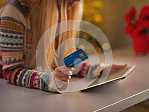 Closeup on teenage girl with credit card using tablet pc