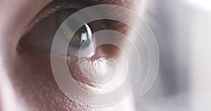 Closeup of teenage girl eye without makeup looking up