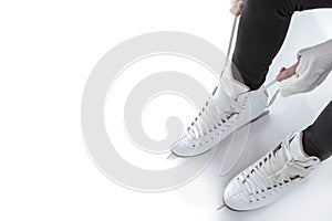 Closeup of Teenager Girl hands Lacing Up Iceskates