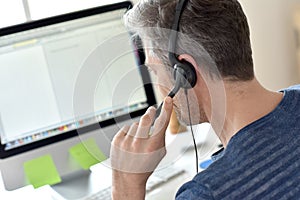 Closeup of telemarketing worker with headset