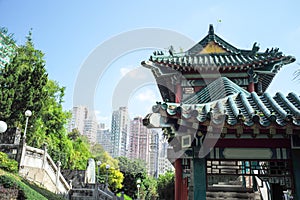 Closeup temple pavilion in Chinese style with crowd of high building and cityscape in background