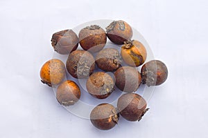 Closeup of Tendu or Diospyros melanoxylon or Persimmon fruit on white surface. photo