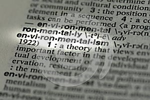 closeup of term and definition of environmentalism printed and highlighted in dictionary on white page.