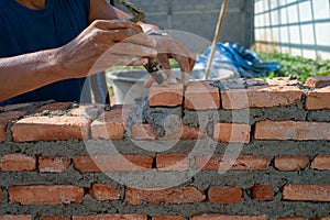 Closeup texture and background of orange bricklayers installed by worker at the construction site photo