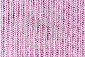The closeup texture of pink cashmere sweater background. Macro shot of knitted fabric from Lana Wool threads photo
