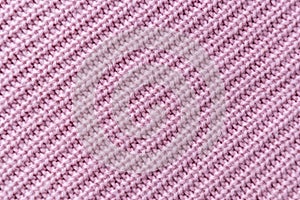 The closeup texture of pink cashmere sweater background. Macro shot of knitted fabric from Lana Wool threads photo