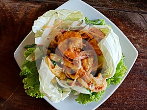 Closeup Thai spicy Fried shrimp salad on table