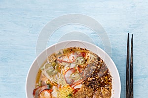 Closeup Thai style spicy egg noodle soup with wanton