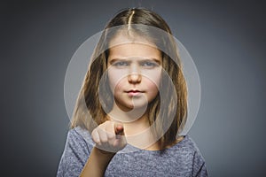 Closeup Thoughtful or contemptuous girl show at camera isolated on Gray