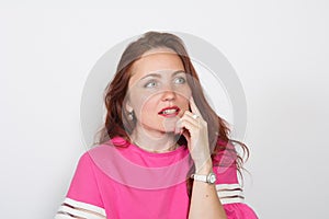 Closeup of a thoughtful red-haired woman looking away isolated on white background