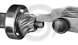 Closeup of thread pitch gauge measurement on gear wheel pinion isolated on a white background