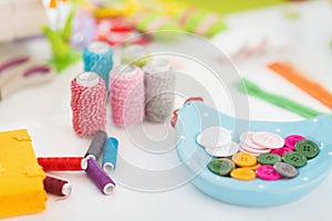 Closeup on threads and buttons on table for easter