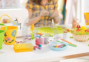 Closeup on threads and buttons on table