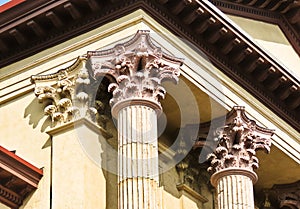 Closeup of three corinthian columns at a courthouse.