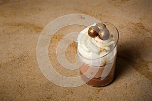 closeup three-layered mousse dessert in small plastic cup