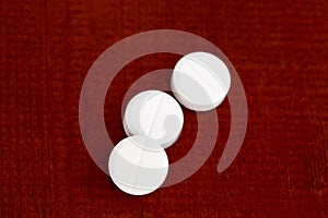 Closeup of three white pills