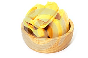 Closeup of three yellow jackfruit on woodwn cup white background