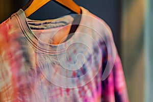 closeup of a tiedye tshirt on a hanger