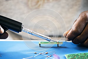 Closeup of tin soldering with electronics circuit board