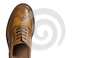 Closeup of Tip Medalion of One Brogue Derby Shoe of Calf Leather with Rubber Sole Over Pure White Background