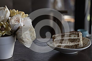 Closeup tiramisu cake at coffee shop in a wooden table