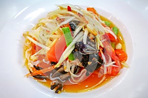 Closeup to Famous Thai food, papaya salad or SOM TAM or Somtum. in white plate.