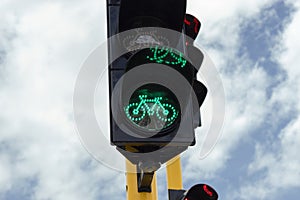 Closeup to a green traffic light near to a vehicular traffic light in a bike path crossroad photo