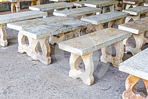 Closeup to Many Dirty Cement Benches in Quiet Place