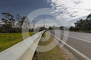 Closeup to a metal safety highway bar in a country field highway curv photo