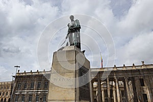 Closeup to a Simon Bolivar monument located at downtown simon bolivar square with presidential palace behind