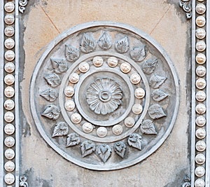 Closeup to Symbol of Buddhism, Rowel Stucco in Temple photo