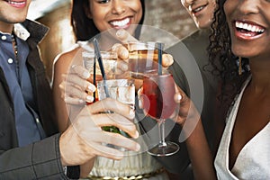 Closeup Of Toasting Drinks At Bar photo