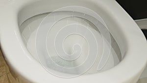 Closeup toilet flushing interior video 4k