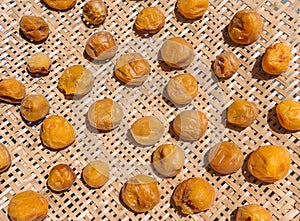 Closeup on Japanese umeboshi salted plums dried on a zaru colander made from bamboo. photo