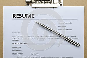 Closeup and top view of resume form on the clipboard and silver pen photo
