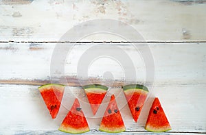 Closeup top view shot tropical organic juicy healthy tasty fruit red triangle sliced watermelon pieces with green peel black seeds