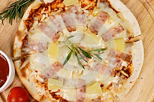 Closeup top view studio shot of round hot oven baked tasty delicious Italian homemade ham pineapple original Hawaiian soft bread