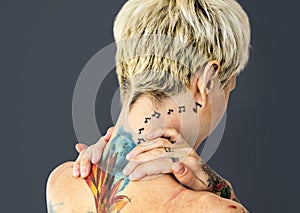 Closeup of topless woman with tattoo